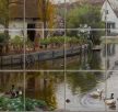 Tile mural with countryside lake scene, ducks, geese, and rustic cottages